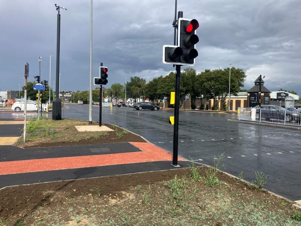 A main road with resurfaced paths and road, with new road markings.