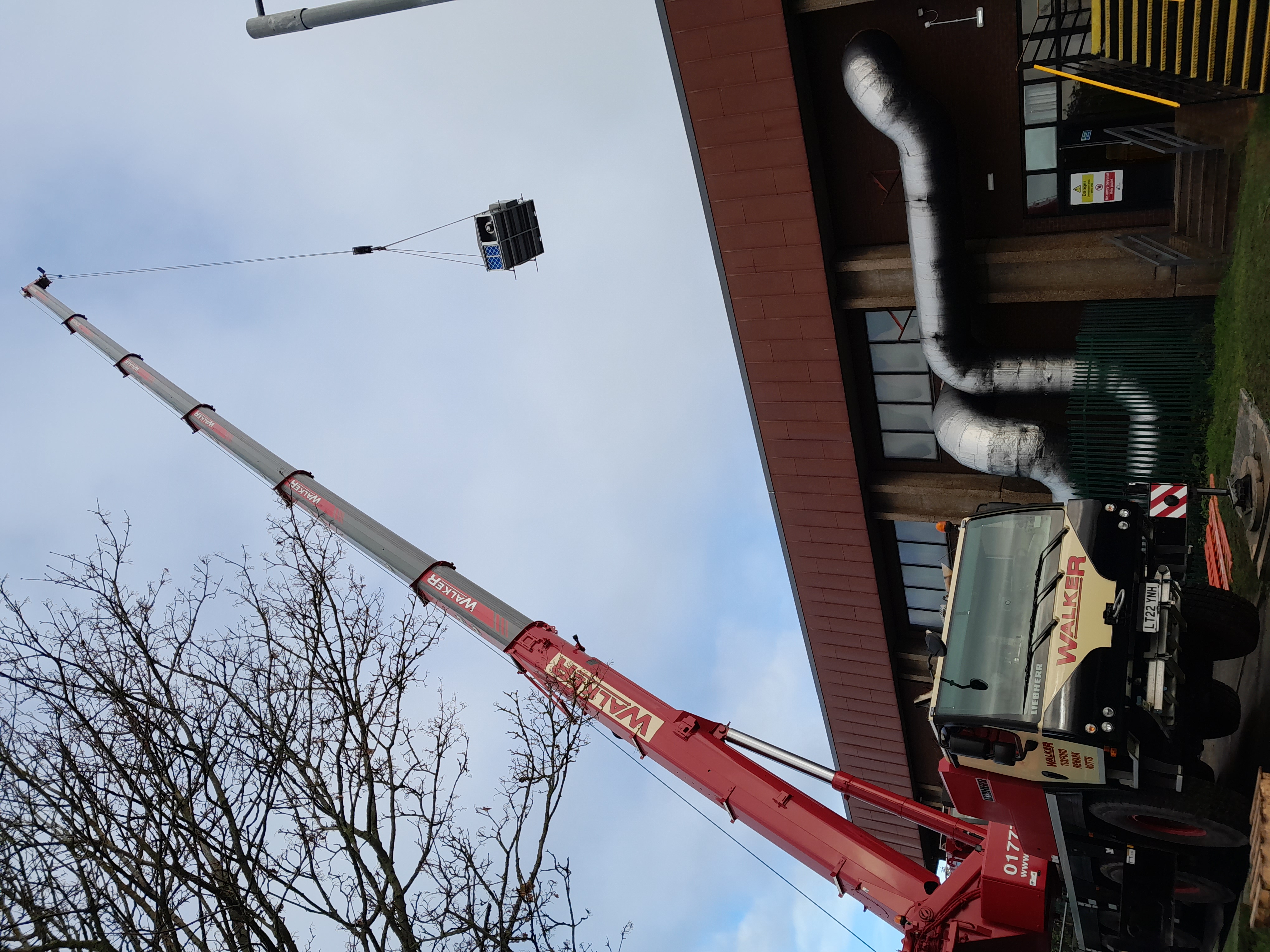 ventilation unit being craned onto the roof
