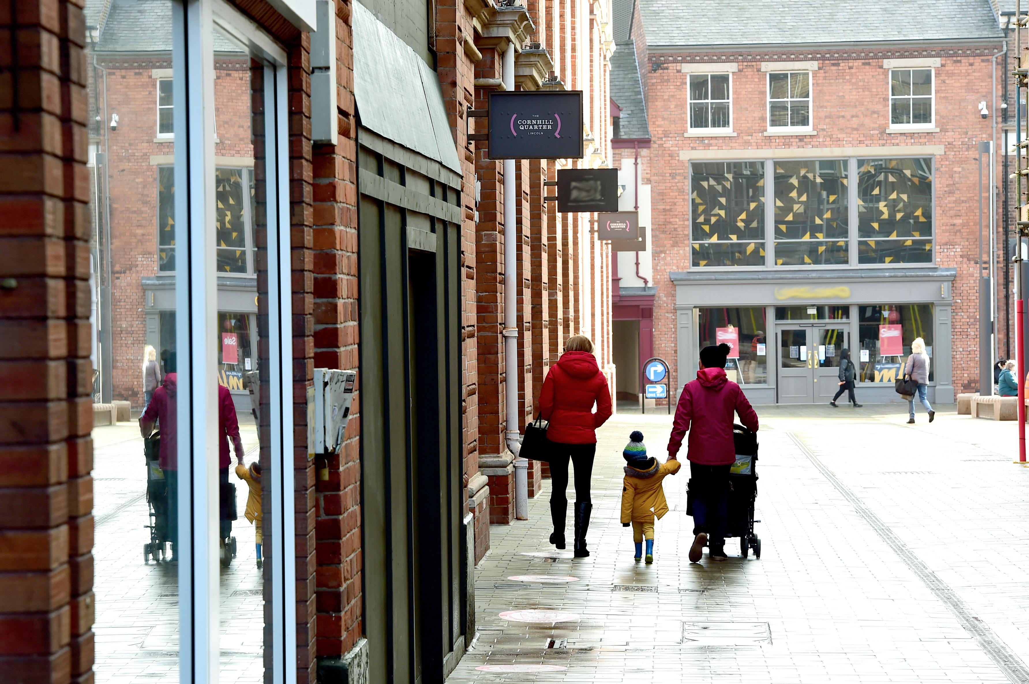 A photograph of passers by at Lincolns Cornhill quarter