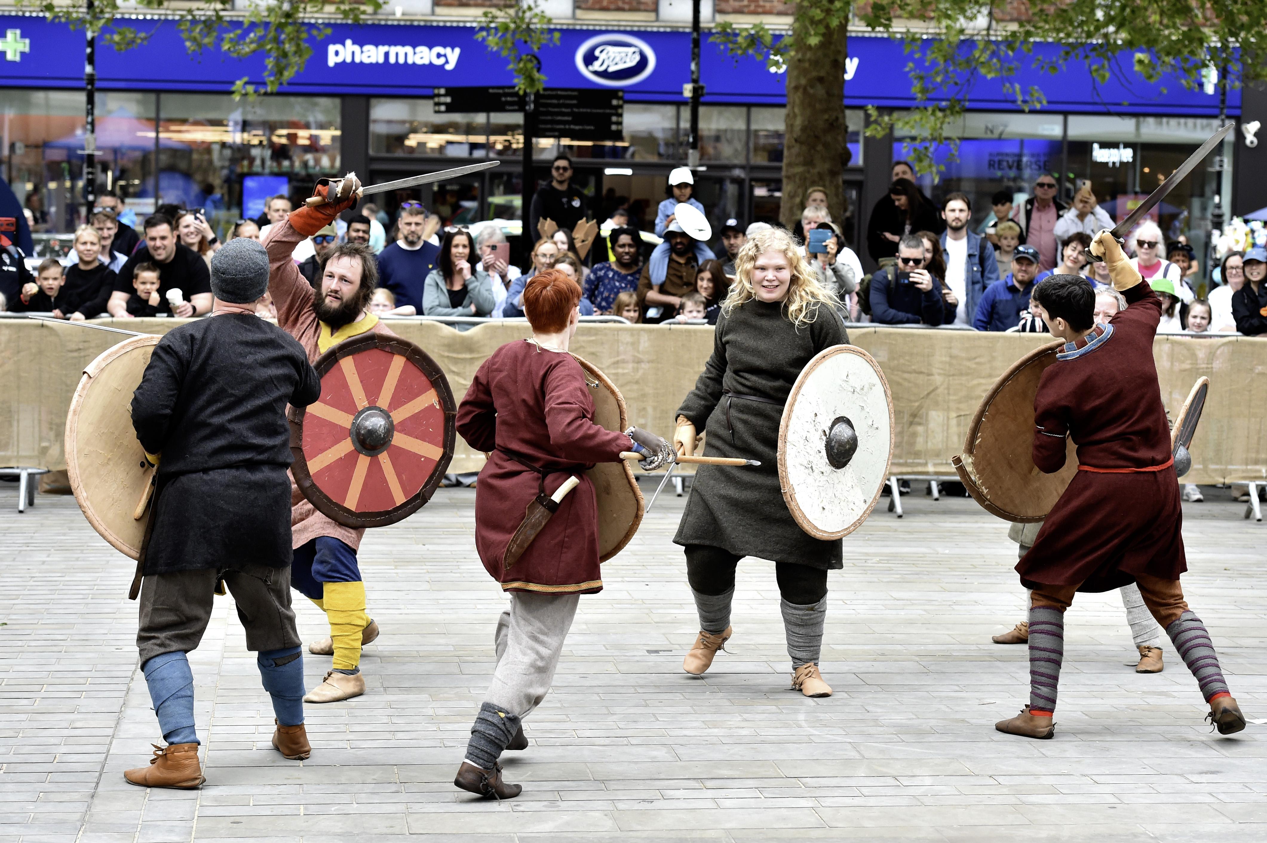 Five people dressed up in a battle re-enactment.