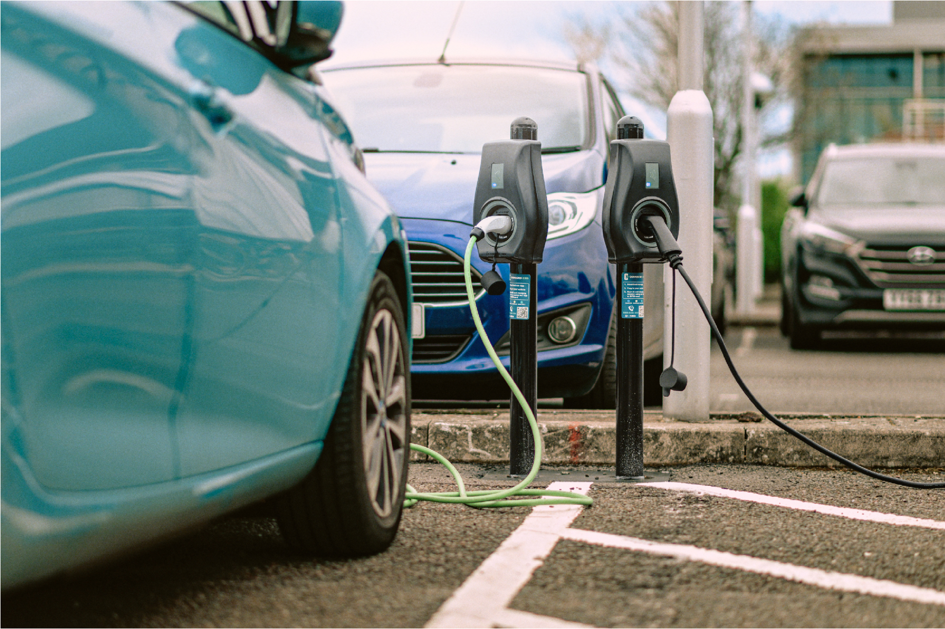 image shows two cars plugged into EV chargepoints