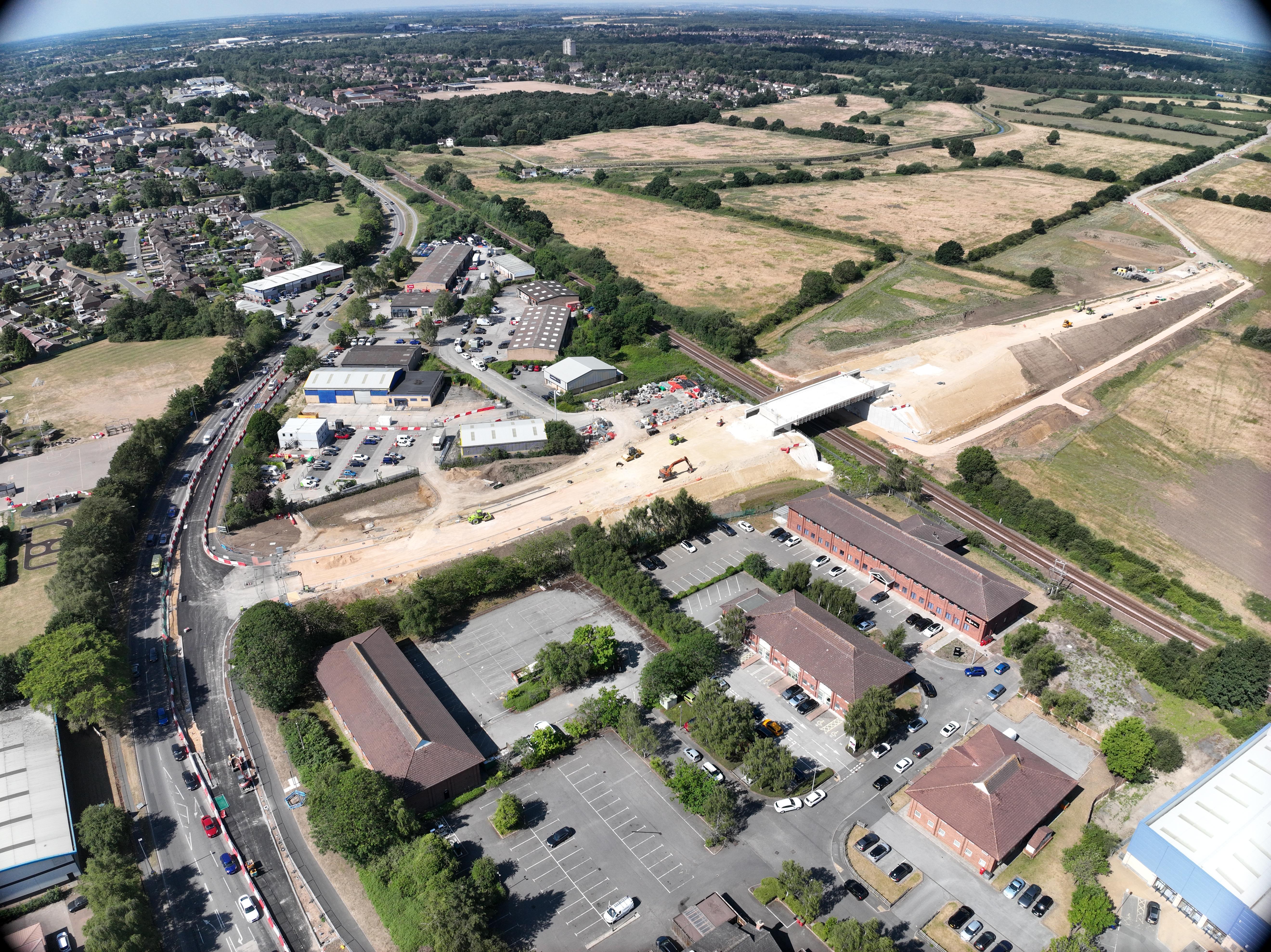 An aerial shot of a bridge under construction off of Tritton Road, across the railway line and onto the Charterholme site.