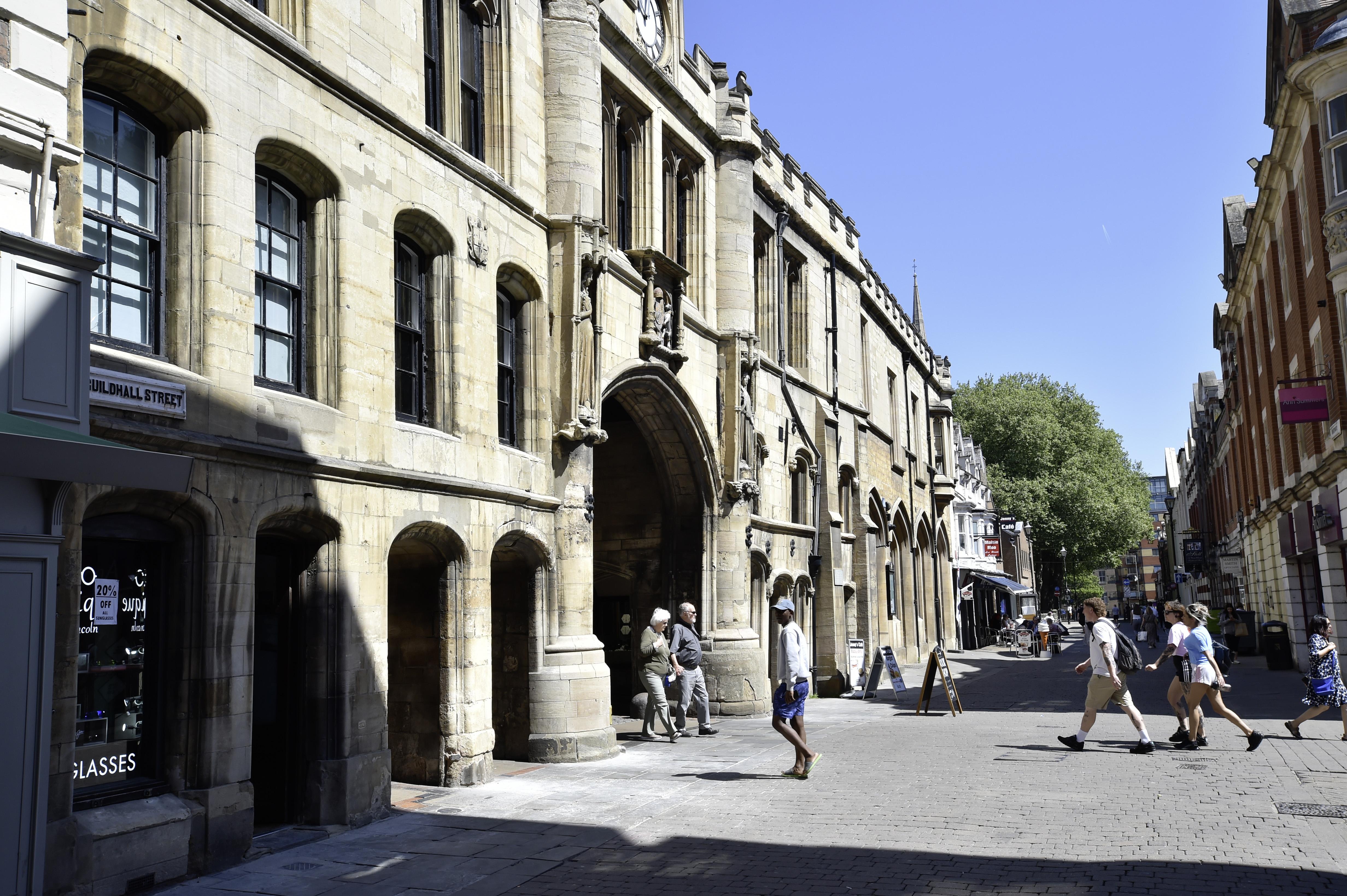 A side on view of Lincoln's Guildhall in the sun.