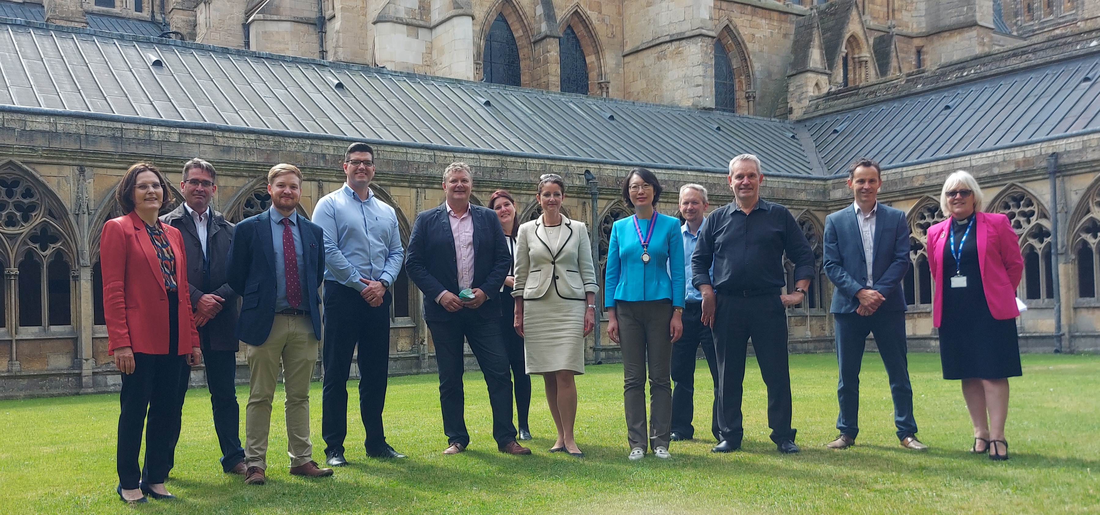 Group photo of visitors and staff outside Lincoln Cathedral