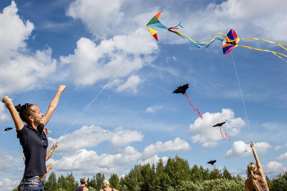 Children flying kites in a park