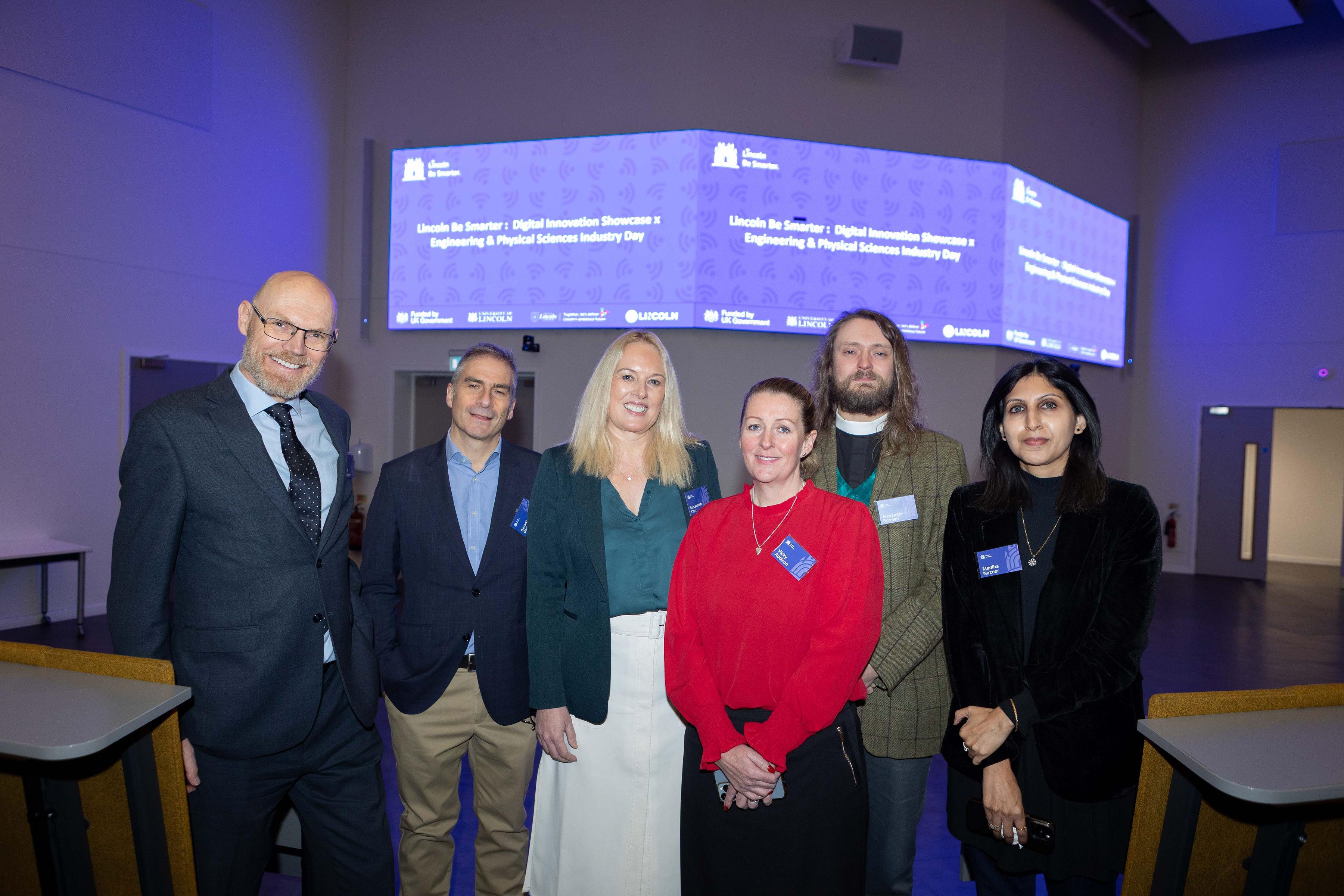 The team behind Lincoln Be Smarter's final networking event stand in front of the hall where the event took place.