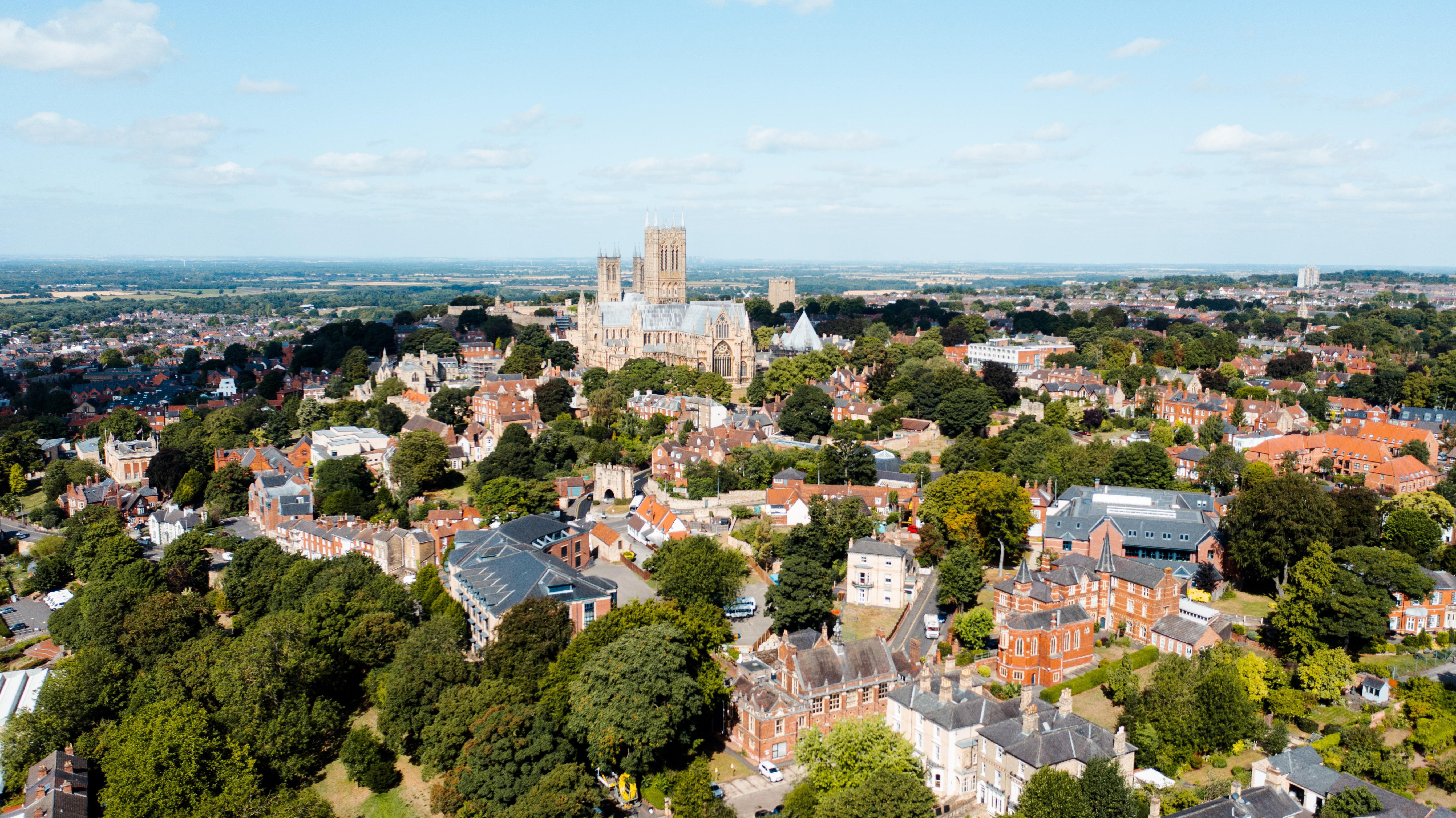 A drone photo of Lincoln city with Lincoln Cathedral in the background.