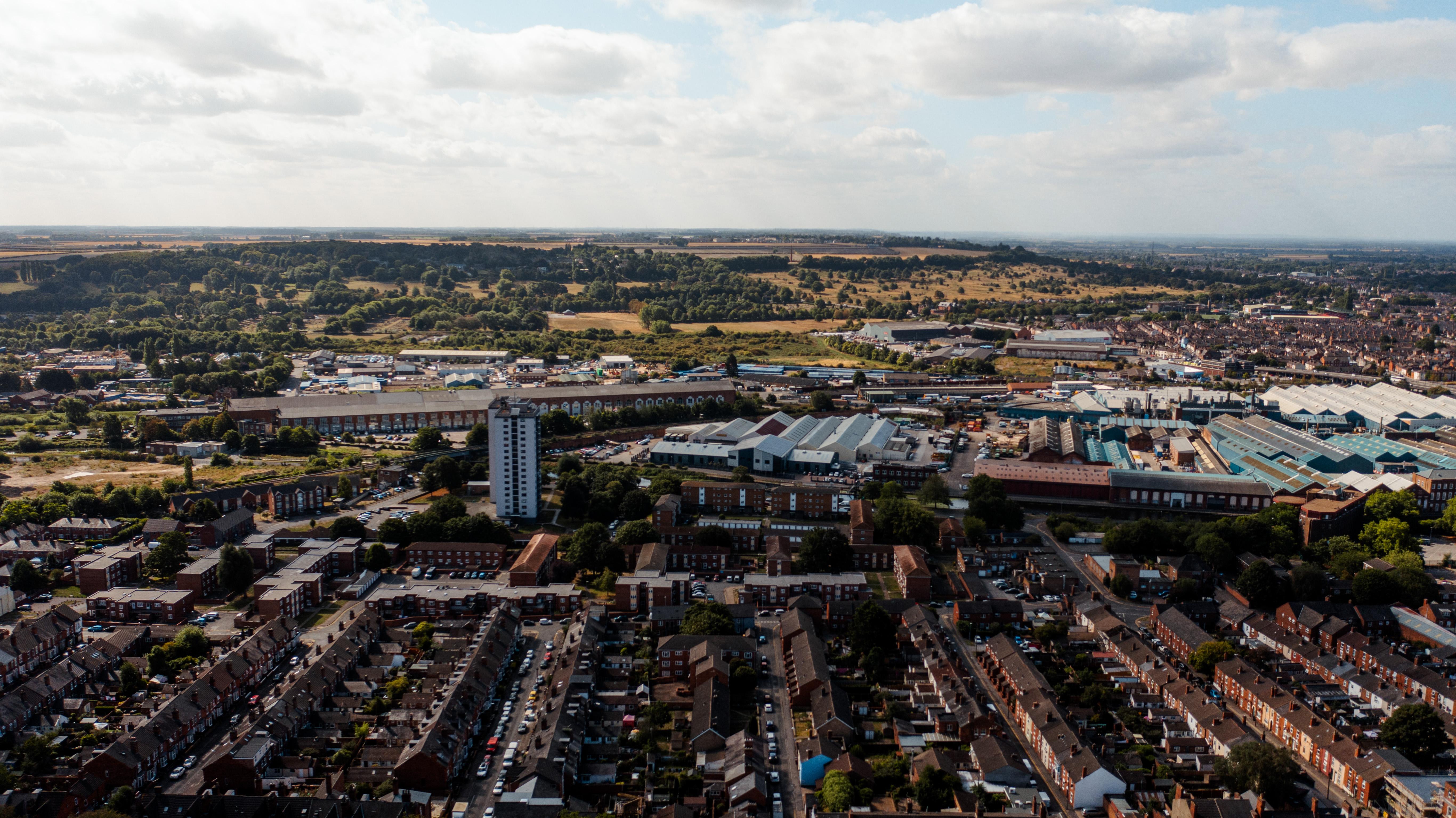 A drone shot of the city of Lincoln, houses, the university and high rise buildings can be seen.