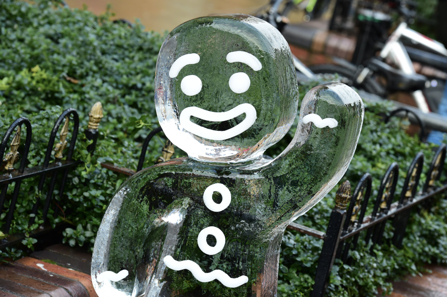 Zoomed in image of an ice sculpture in the shape of a waving gingerbread man.