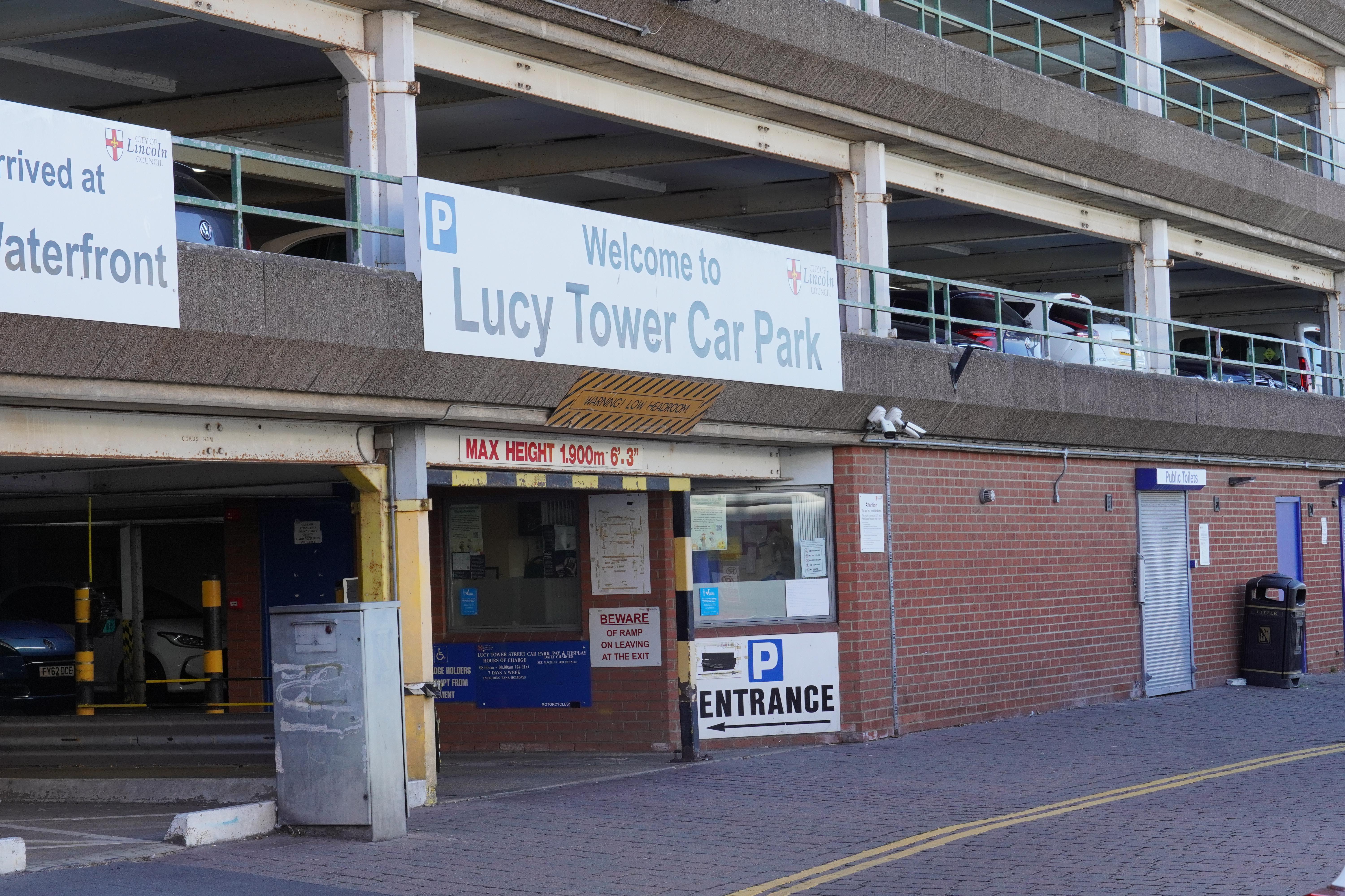 The entrance to a multi-storey car park. The sign above the entrance reads Lucy Tower Car Park.