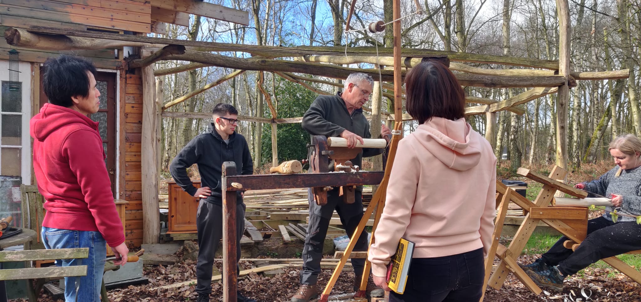 Image shows participants taking part in the wood work class