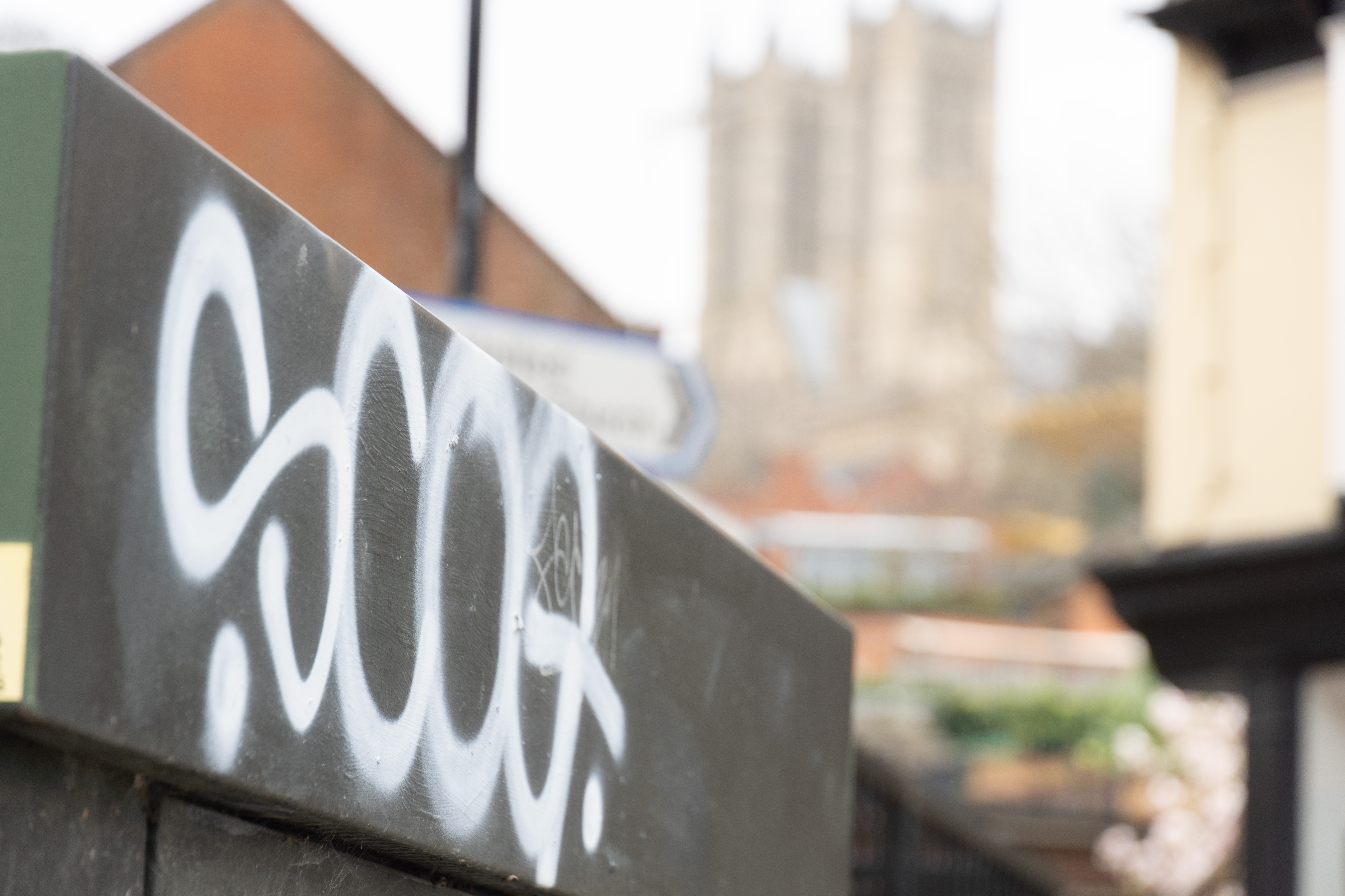 image shows graffiti on a wall with the cathedral in the background