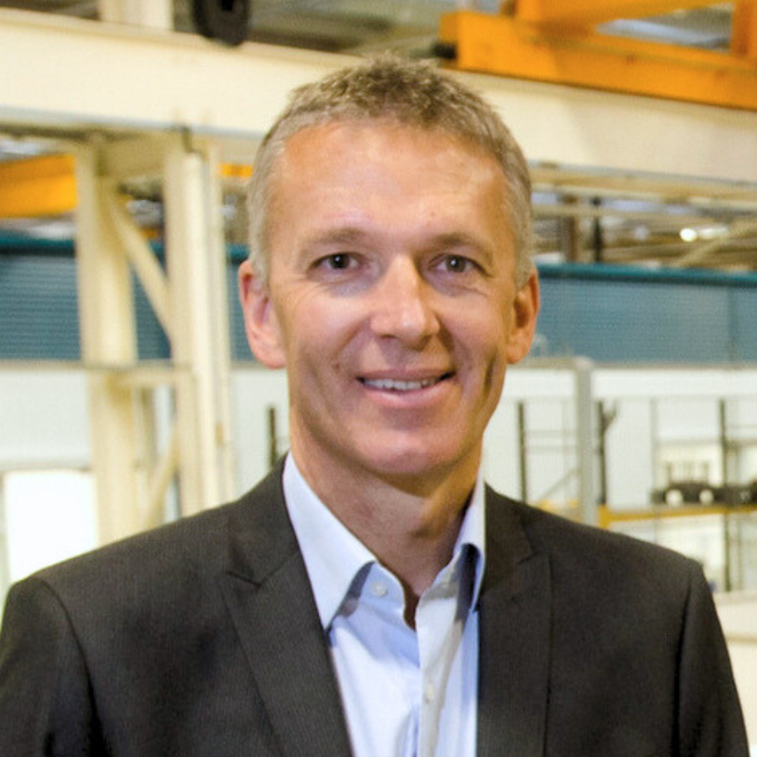 Neil Corner poses for a headshot photo in the Lincoln Siemens factory.