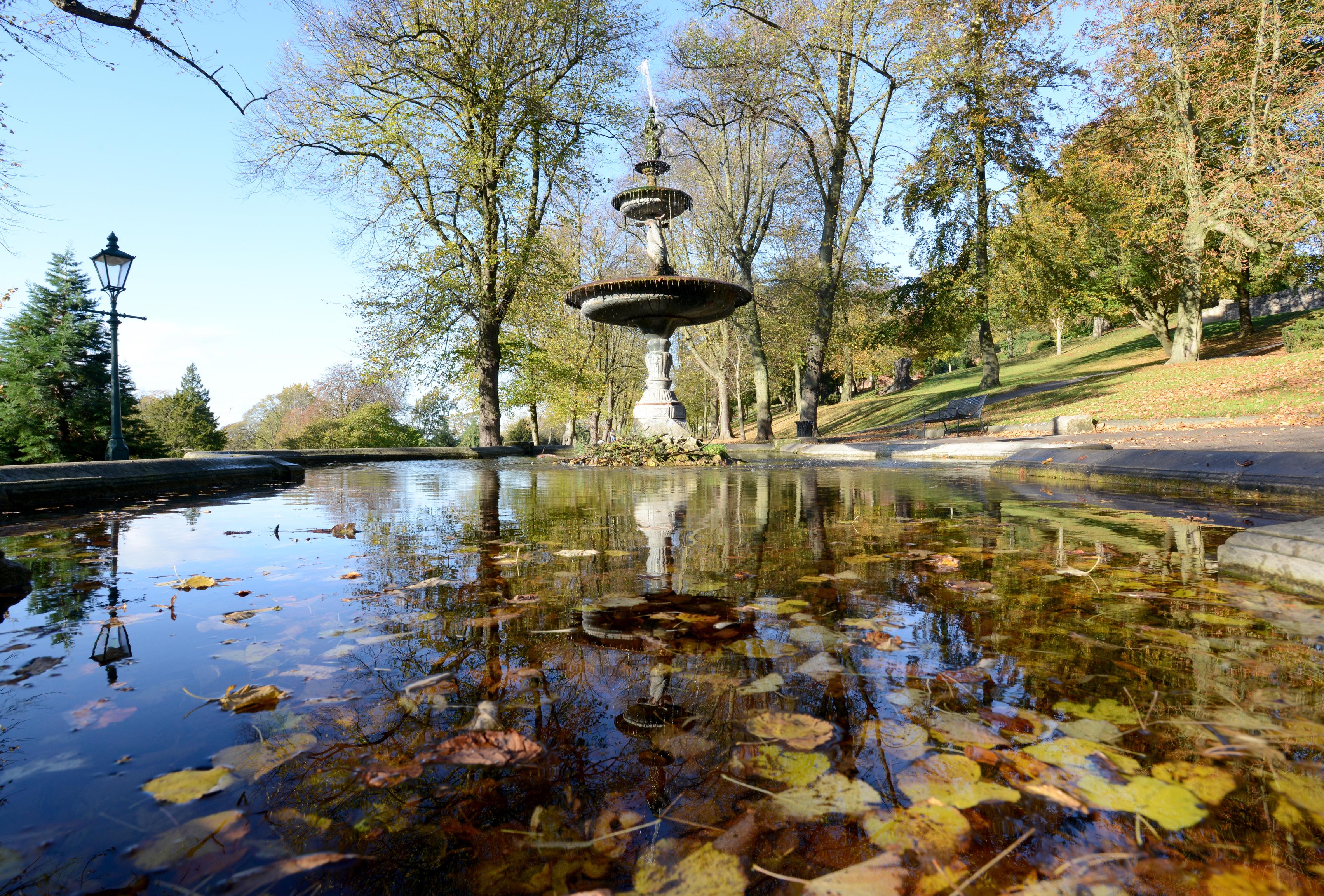 A manmade pond with a water fountain in the middle.