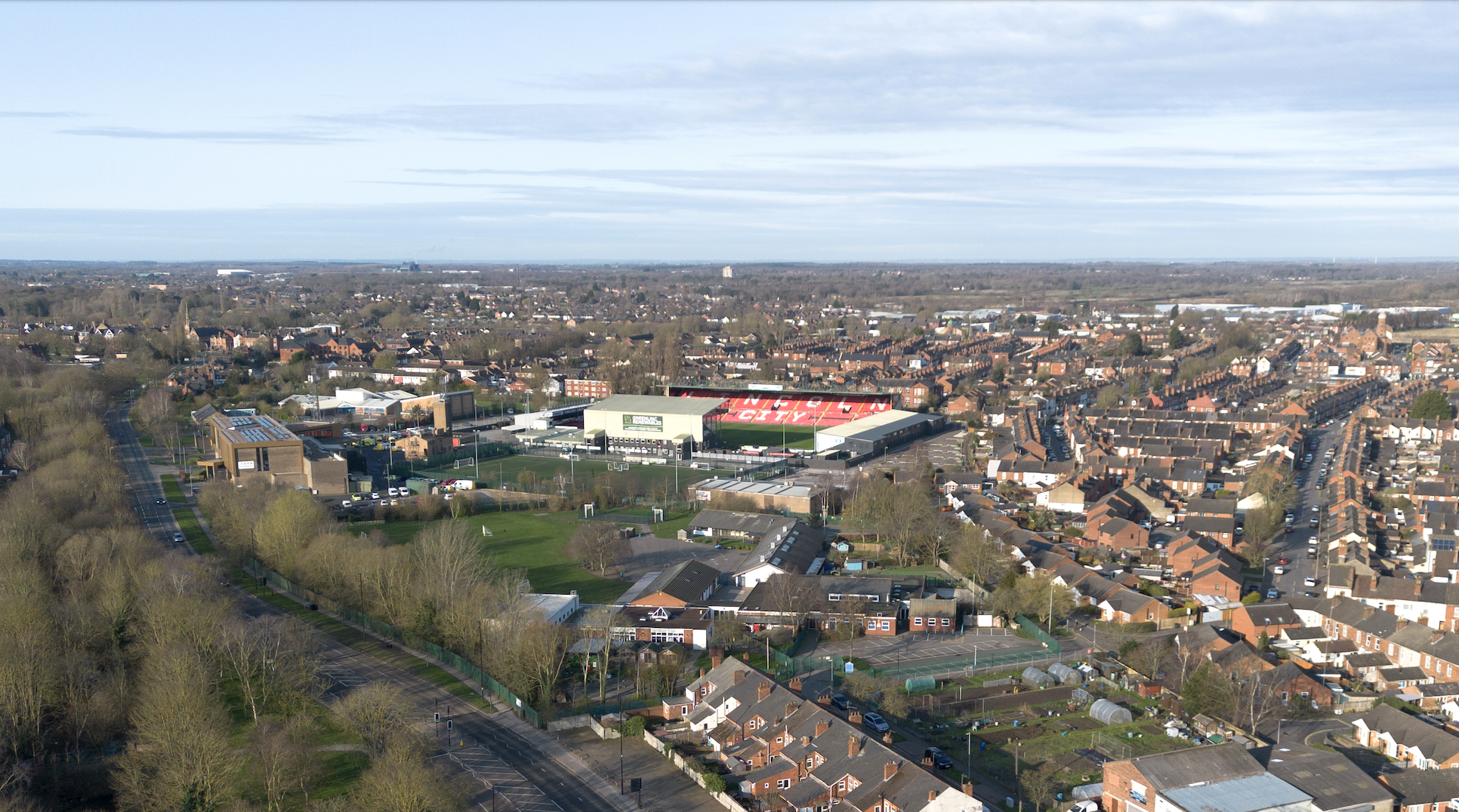 A drone photo taken from the south side of the city where the football stadium can be seen surrounded by terraced houses.