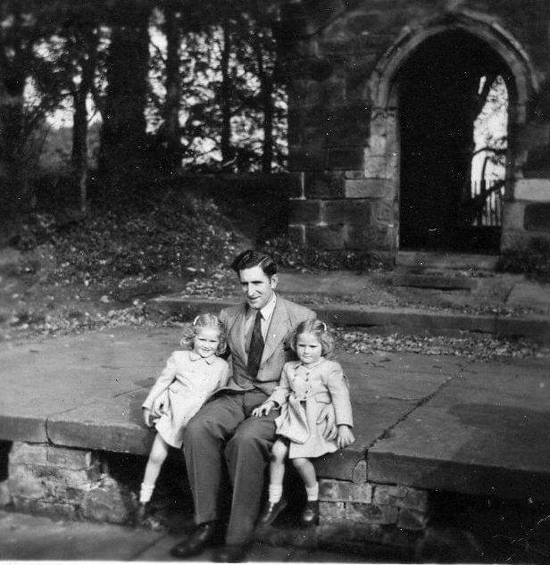 Picture of a man with his daughters.