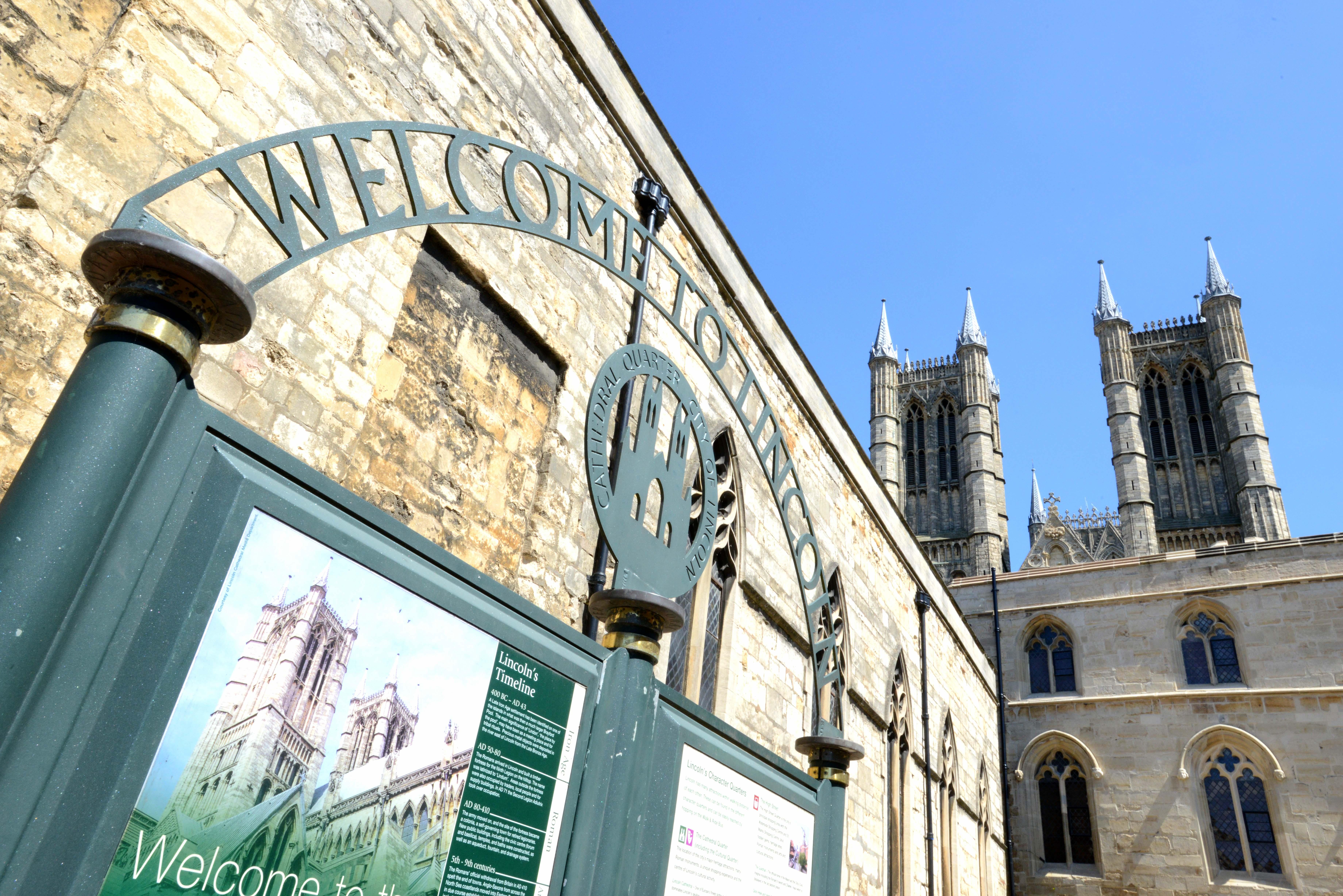 Welcome to Lincoln sign with blue sky and Lincoln Cathedral in the background