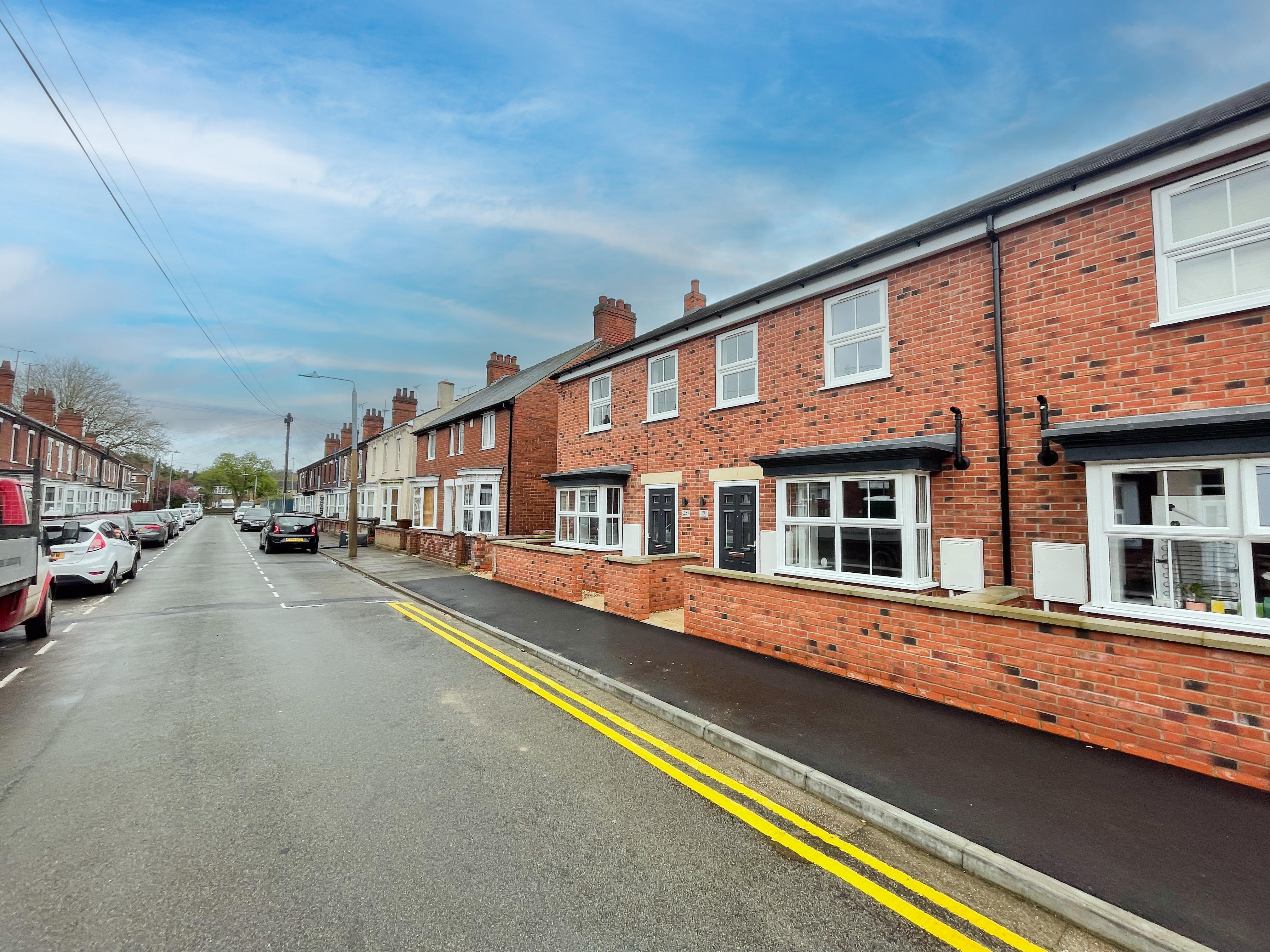 A row of brick houses on a street.