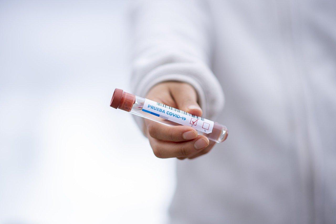 Lab scientist holding a Coronavirus test tube